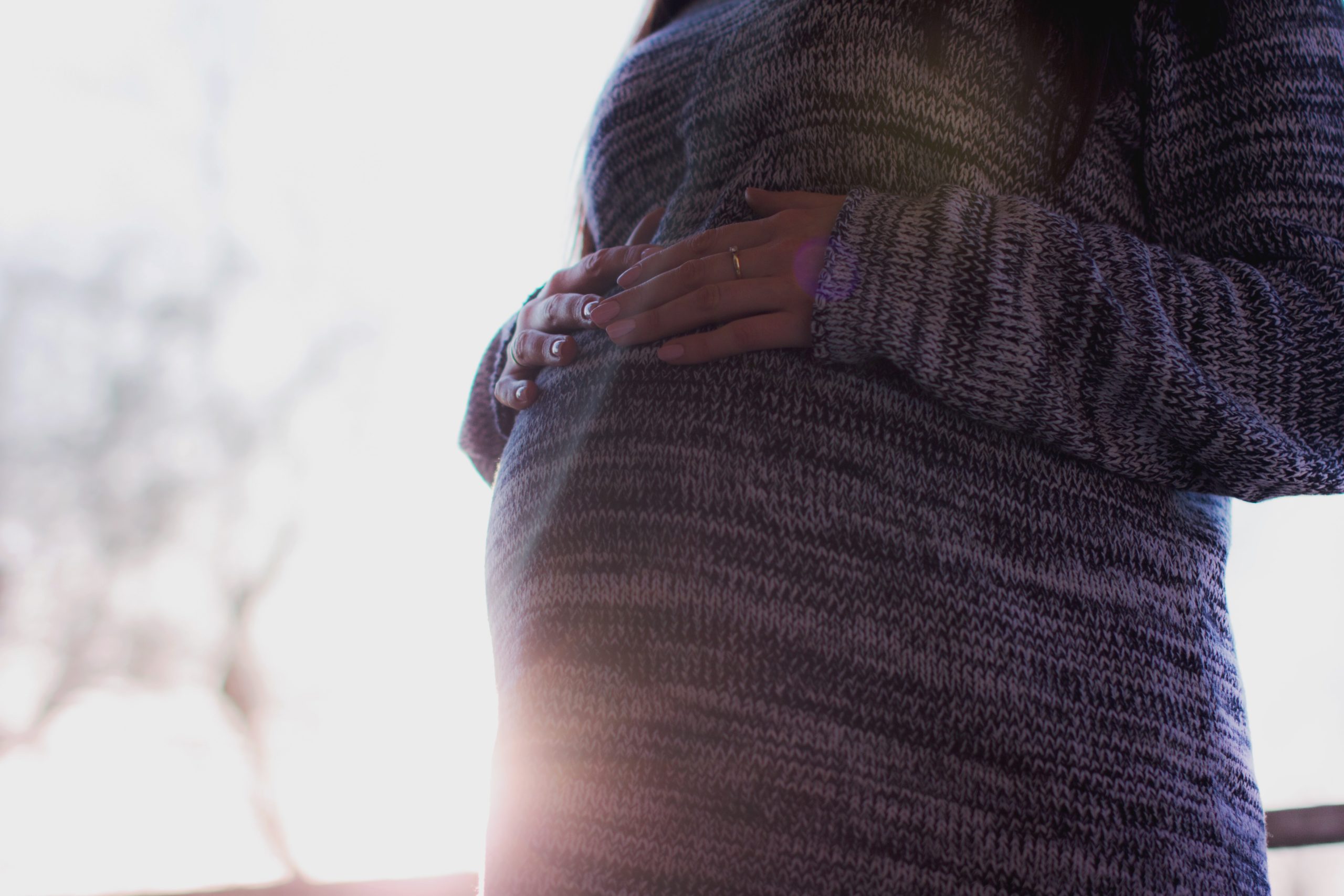 Photo Pregnant belly with heather knit sweater dress unsplash